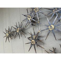 several metal stars are hanging on the wall