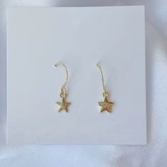 Add a hint of celestial charm to your look with our Dainty Star Charm Earrings! Featuring delicate star-shaped charms on gold or silver French wire hooks, these lightweight earrings are perfect for adding a touch of shimmer to your everyday style. Whether you’re strolling the beach or out for a night under the stars, these trendy earrings bring a subtle yet chic coastal vibe to any outfit. MATERIALS: gold: 14k gold plated brass base premium metal 18k gold-filled (hypoallergenic) silver: silver p Elegant Star-shaped Nickel-free Hoop Earrings, 14k Gold Filled Earrings With Star Charm As Gift, Everyday Star-shaped Tarnish Resistant Earrings, Tarnish Resistant Star-shaped Everyday Earrings, Everyday Star-shaped Tarnish-resistant Earrings, Minimalist Star-shaped Tarnish Resistant Earrings, 14k Gold-filled Silver Earrings As Gift, Gold Plated Star-shaped Hoop Earrings, Dainty Star Charm Drop Earrings