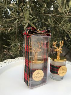 two christmas candles in a clear gift box