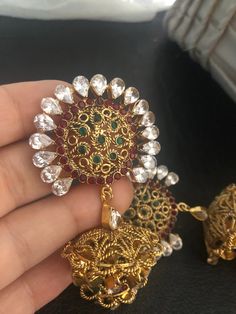 Complete your look this festive season with our beautiful dubble layer jhumka earrings with semi precious ruby and emerald stones and kundan work. A gorgeous pair of jhumka earrings to light up your day any time! In stock and ready to ship. Temple Jewelry Style Jhumkas For Party, Temple Jewelry Jhumkas For Party, Temple Jewelry Style Party Jhumkas, Traditional Drop Jhumkas With Stone Work, Temple Jewelry Style Jhumkas With Latkans For Party, Traditional Jhumkas With Stone Work, Traditional Stone Work Jhumkas, Stone Work Drop Jhumkas For Celebration, Festive Tilla Drop Earrings Jhumkas