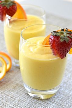 two glasses filled with pudding and orange slices