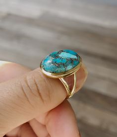 14k gold filled turquoise ring. 14 karat gold filled sterling silver and 13mm x 17.5mm stabilized copper infused turquoise. The band is 4mm. This ring is available in whole sizes. Material: 14k gold filled Sterling Silver Stone Size: 13mm x 17.5mm Coming with gift box RETURN POLICY : For any reason, if you are not satisfied with our product, you may return your order within 10 days from the date of shipment received. The item must be returned in its original condition. Shipping charges are not r Big Turquoise Ring, Handmade Turquoise Ring In Yellow Gold, Handmade Yellow Gold Turquoise Ring, Gold Turquoise Ring With Gemstone, Gold Turquoise Ring Gift, Gold Turquoise Ring For Gift, Oval Gold Turquoise Ring Fine Jewelry, Adjustable Gold Turquoise Ring With Oval Shape, Adjustable Gold Turquoise Gemstone Ring