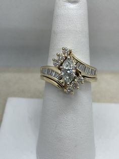 a white ring with two rows of diamonds in it on top of a napkin holder