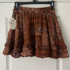 Nwt Western Style Ruffle Skirt. Super Cute Pattern Brown Skirted Bottoms With Ruffled Skirt, Brown Skirted Bottoms With Ruffled Detail, Brown Ruffled Skirt Bottoms, Brown Ruffled Skirted Bottoms, Fall Bohemian Mini Skirt, Spring Flowy Brown Skirt, Flowy Skirt For Fall Vacation, Casual Brown Ruffled Mini Skirt, Casual Brown Ruffled Skirt