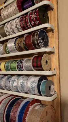 a wall mounted spice rack filled with lots of different types of spices