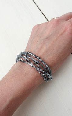 Beaded Layered Bracelet Gray Seed Beads Multi Stranded Multi-strand Silver Beaded Bracelet As Gift, Silver Multi-strand Bracelets With Spacer Beads, Handmade Silver Multi-strand Wrap Bracelet, Adjustable Multi-strand Silver Beaded Bracelets, Beaded Multi-strand Wrap Bracelet, Silver Multi-strand Faceted Beads, Silver Double Strand Beaded Bracelet, Gray Beaded Multi-strand Jewelry, Silver Beaded Double Strand Beads