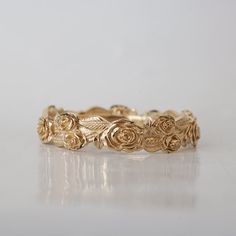 a gold ring with roses on it