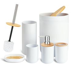 white bathroom accessories including toothbrush holder, soap dispenser, and cup