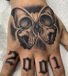 a hand with two skulls on it and the number 10 written in black ink is shown