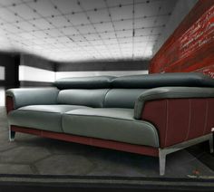 a red and grey leather couch sitting on top of a floor next to a wall