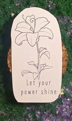 a sign that says let your power shine on the side of a grass covered field