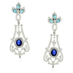 Introducing our exquisite Chandelier Earrings, a luxurious tribute to European elegance and opulence. Inspired by the grandeur of classic European chandeliers mixed with nature motifs, these stunning earrings are adorned with 3.05 carats of sparkling white round diamonds, creating a dazzling cascade of light and brilliance. Adding a rich depth of color are two oval-shaped blue sapphires totaling 3.46 carats, complemented by six oval-shaped apatites totaling 1.46 carats, which enhance the earrings' vibrant allure. Crafted in 18K white gold and weighing 18.42 grams, these earrings exude sophistication and timeless beauty. Perfect for any special occasion, these Chandelier Earrings are designed to make a statement with their intricate craftsmanship and radiant colors. Embrace the elegance and European Modern, Nature Motifs, European Elegance, Big Diamond, Jewel Box, Stunning Earrings, Dream Jewelry, Chandelier Earrings, Timeless Beauty