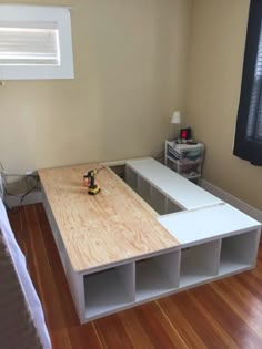 a bed room with a wooden floor and a window in it's side wall