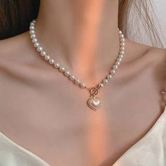 This Is A Simulated Pearl Choker Necklace. Pendant Is Heart Shaped Lined With Some Crystals. Perfect For Wedding Engagements, Formal Party And Any Other Social Gathering. Excellent Piece When In Gown Or Sunday's Best Dresses. Girly Pearl Necklace, Pearl Heart Bead Necklace, Coquette Beaded Necklaces, Heart-shaped Pearl Beaded Necklace For Valentine's Day, Elegant Beaded Heart Necklace, Heart-shaped Pearl Necklace, Valentine's Day Heart-shaped Pearl Beaded Necklace, Pearl Necklace With Heart-shaped Beads, Pearl Bead Necklace