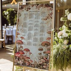 a sign with mushrooms on it in front of flowers