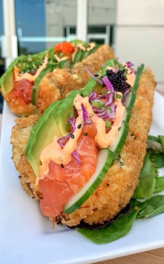 some type of appetizer on a white plate with greens and other food items