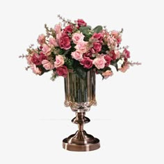 a vase filled with pink flowers sitting on top of a metal stand next to a white wall