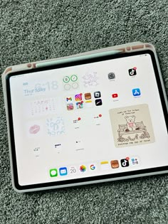 an ipad with stickers on it laying on the floor