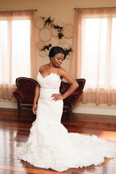 a woman in a wedding dress posing for the camera