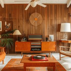 a living room with wood paneling and furniture, including a coffee table in the center