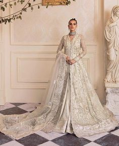 Detailed florals bloom in moonlit tendrils on the dreamy ivory organza canvas of Un Pavot, luxuriously laden with iridescent sequin, sparkling crystal and oyester pearls with dabka work creating an ethereal impact. Paired with an ivory organza foil print dupatta emblazoned with filigreed bootis, elaborately detailed borders and dramatically accented pants, this look is reminiscent of royal regalia and a perfect choice for any and all formal occasions. White Pakistani Wedding Dress, Maxi Pakistani, Republic Womenswear, Embroidery Gown, Maxi Frocks, Pakistani Art, Dabka Work, Mehndi Party, Embroidery Clothes