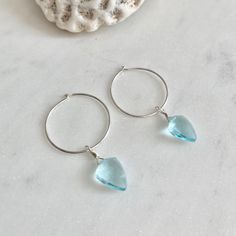 Dainty little aquamarine faceted crystal gemstone hoop earrings in 20mm sterling silver or 14k gold filled hoops. Option for gold plated and silver plated are less expensive. Please see drop down. Perfect for March birthdays! 💙Aquamarine, a stone of serenity, calms and soothes with it's lovely blue/green color and evokes the calm of the water with it's given name, which is interpreted at 'water of the sea' derived from Latin. A stone that celebrates the sea goddess of ancient times, it was carr Blue Hypoallergenic Hoop Jewelry, Hypoallergenic Blue Hoop Jewelry, Blue Hypoallergenic Small Hoop Jewelry, Hypoallergenic Blue Small Hoop Jewelry, Nickel-free Blue Small Hoop Jewelry, Blue Small Hoop Jewelry For Anniversary, Blue Teardrop Hypoallergenic Hoop Earrings, Small Hoop Birthstone Jewelry For Everyday, Everyday Small Hoop Birthstone Jewelry