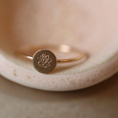 a gold ring with a small flower on it