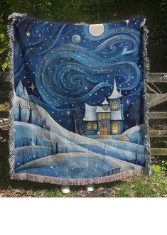 a blanket with a painting on it that looks like a night sky and stars in the sky