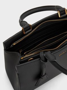 This product is made with at least 20% sustainable materials by weight. CHARLES & KEITH uses recycled, degradable, organic, and water-based materials in our eco-conscious collection. A polished carry-all is a wardrobe essential for the modern woman on the go, and the sleek Mirabelle structured top handle bag fits the bill. Its minimal black exterior exudes sophistication, complete with a gold-accent bag charm for visual interest. The secure zip closure opens up to a roomy interior that will fit everything you need and more. You can easily tote it by the sturdy top handles, or clip on the adjustable strap to sling it on the shoulder. Luxury Top Handle Shoulder Bag With Gunmetal Hardware, Black Purse Gold Hardware, Structured Bags For Women, Black Satchel Bag, Dark Academia Outfit, Belt Ring, Structured Top, Structured Bag, Uni Outfits