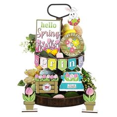 a cake that is sitting on top of a wooden stand with flowers and bunting