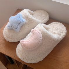 two pairs of slippers sitting on top of a wooden table