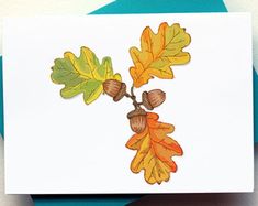 a card with leaves and acorns on it