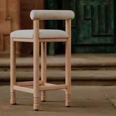 a close up of a wooden chair on the ground