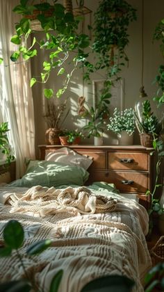 an unmade bed with green plants in the corner