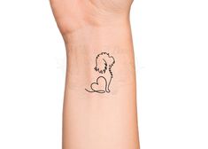 a hand with a small dog tattoo on it's left wrist and the outline of a poodle