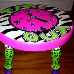 a pink and green stool with zebra print on it