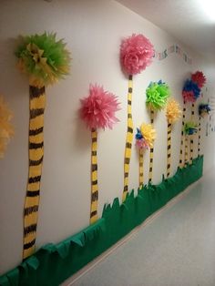 the wall is decorated with paper flowers and palm trees