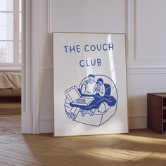 the couch club sign is displayed in front of a white wall and wood flooring