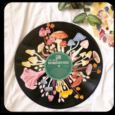 a record with flowers painted on it