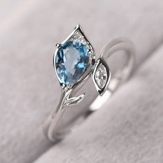 ◆ The ring is handcrafted from sterling silver and decorated with a dazzling 5*7 mm London blue topaz and CZs. It is suitable for engagement/anniversary/daily occasion. ◆ Production Description: Main stone Type: Real London Blue Topaz Main Stone Shape: Pear Cut Main Stone Size: 5*7 mm(0.97ct) Side stone: CZ Metal: 925 Sterling silver - Other options available in the drop down menu ◆ Customization: √Free for Add Engraving √Other Metal Type Available √Other Gemstones & Shapes Available √Person Fine Jewelry Blue Topaz Ring In Diamond White, Diamond White Blue Topaz Ring Fine Jewelry, Diamond White Blue Topaz Ring For Gifting, Diamond-accented Topaz Ring As A Gift, Gift Diamond Topaz Ring With Gemstone Accents, Diamond Topaz Ring With Gemstone Accents For Gift, Gift Topaz Ring With Diamond And Gemstone Accents, Blue Topaz Birthstone Diamond Ring, Elegant Blue Topaz Proposal Ring