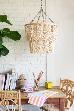 a wooden table with chairs and a hanging chandelier