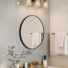 a white sink sitting under a round mirror in a bathroom