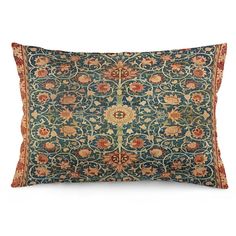 a blue and red pillow with an intricate design on the front, sitting on a white surface