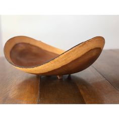 a wooden bowl sitting on top of a wooden table