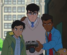 three young men standing next to each other in front of a building with a camera