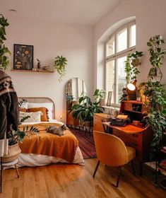 an image of a bedroom with plants on the wall and furniture in the room,