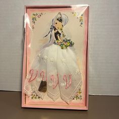 a greeting card featuring a woman in a white dress with flowers on the skirt and hat