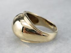 This vintage gold band is simple, yet beautiful on the hand! Sleek and minimalist, this ring has a high-profile dome that tapers gracefully down the shoulders. This band would pair easily with a variety of jewelry! Metal: 14K Yellow Gold Width of Band: 11.9 mm Height off Finger: 4 mm Ring Size: 3.25 Marks: "14K" Stamped on the inside band Classic Ring With Tension Setting And Thick Band, Classic Dome Ring With Wide Band For Promises, Classic Wide Band Dome Ring For Promise, Formal Dome Ring With Polished Edges, Classic Rings With Tension Setting And Wide Band, Classic Wide Band Rings With Tension Setting, Classic Dome Ring With Tension Setting, 14k Gold Domed Ring With Polished Finish, Modern 14k Gold Domed Ring