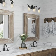 a bathroom with two sinks and mirrors on the wall