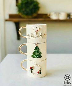 three coffee mugs with christmas decorations on them